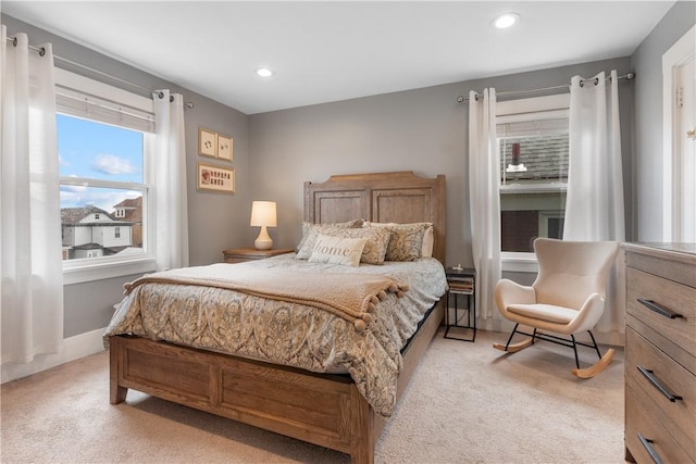 bedroom with light colored carpet and recessed lighting