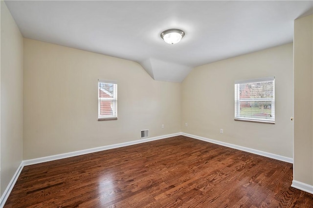 4203 Mckee Dr, Whitehall, PA 15236 - unfurnished room featuring baseboards, vaulted ceiling, visible vents, and dark wood finished floors