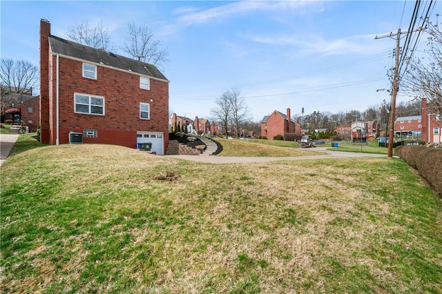 4203 Mckee Dr, Whitehall, PA 15236 - view of yard with a residential view, an attached garage, central AC, and concrete driveway
