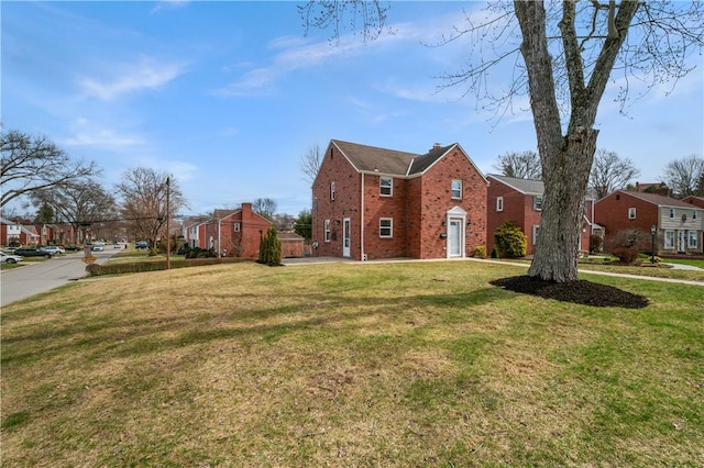 4203 Mckee Dr, Whitehall, PA 15236 - view of property exterior with a lawn, a chimney, brick siding, and a residential view