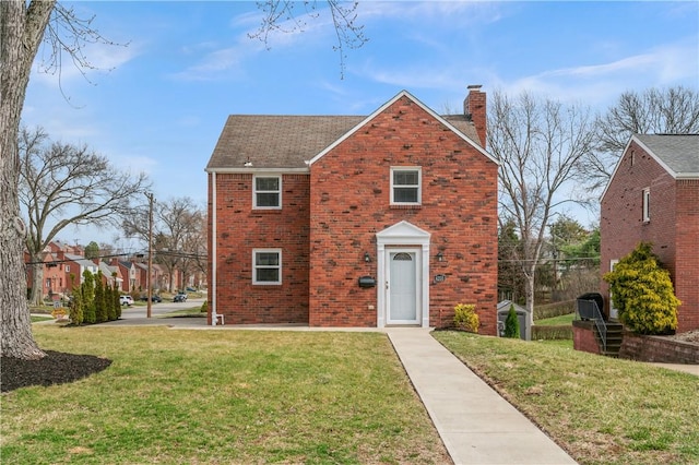 4203 Mckee Dr, Whitehall, PA 15236 - traditional home featuring brick siding, a front lawn, and a chimney
