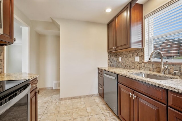 4203 Mckee Dr, Whitehall, PA 15236 - kitchen featuring a sink, tasteful backsplash, visible vents, light stone counters, and appliances with stainless steel finishes