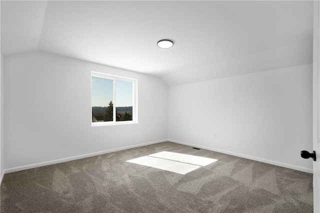 bonus room with baseboards, lofted ceiling, and carpet