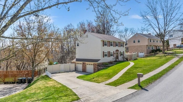 view of front facade featuring fence, a front yard, driveway, and a garage