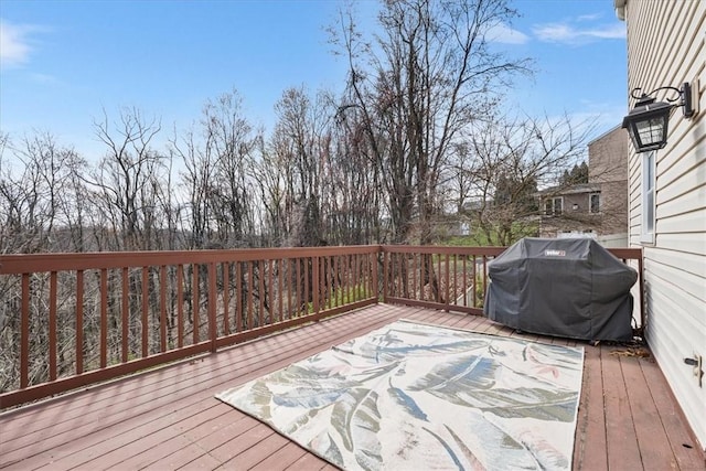 wooden terrace with a grill