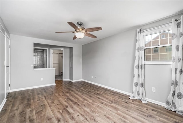 unfurnished bedroom with wood finished floors, baseboards, and ceiling fan