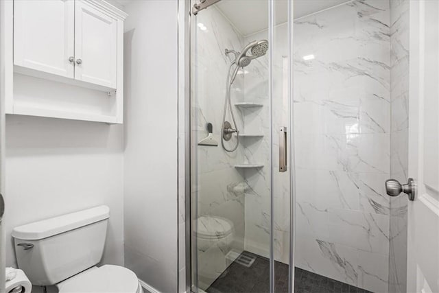 full bathroom with toilet and a marble finish shower
