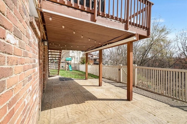 view of patio / terrace with fence and a playground