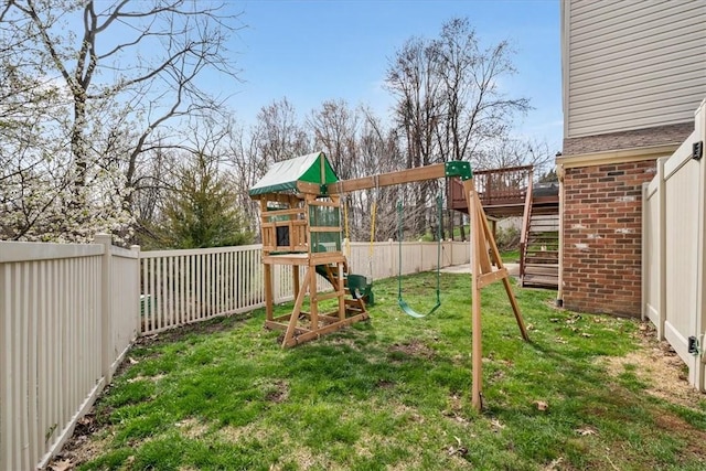 view of jungle gym featuring a fenced backyard, a yard, and stairs