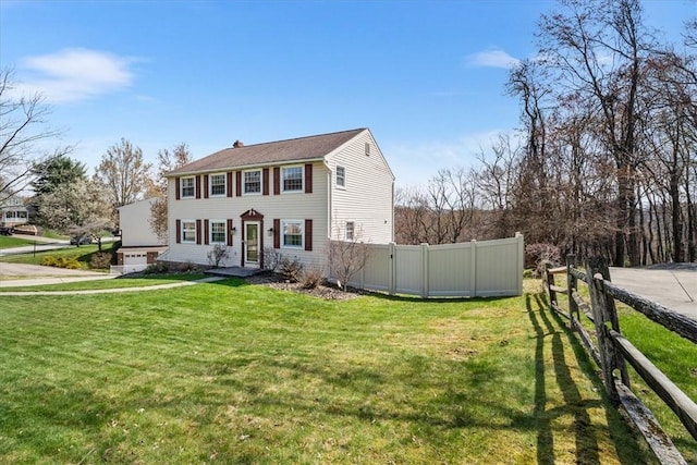 view of front of house featuring a chimney, a front yard, and fence