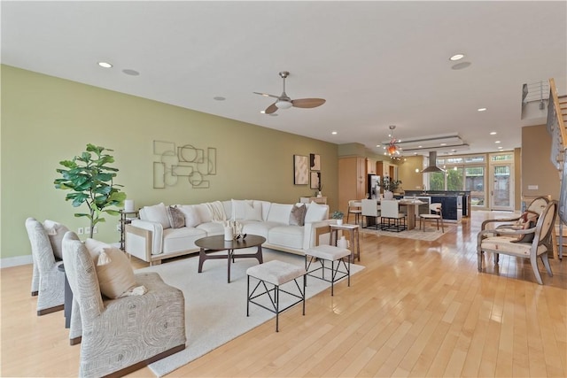 living room with recessed lighting, light wood finished floors, and ceiling fan