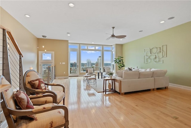 living room with recessed lighting, light wood-style flooring, baseboards, and ceiling fan