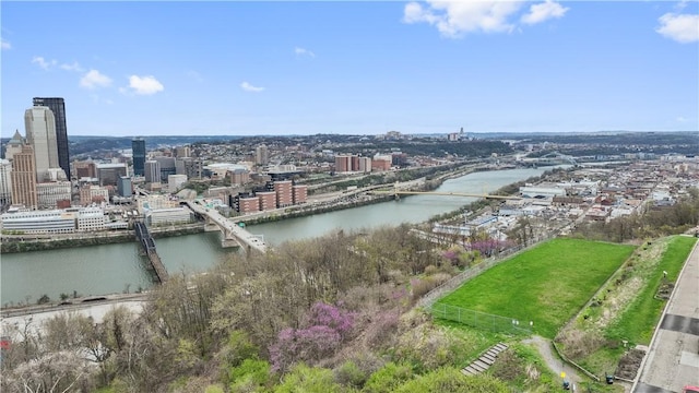 birds eye view of property with a view of city and a water view