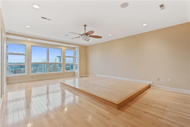 empty room featuring recessed lighting, visible vents, light wood-type flooring, baseboards, and ceiling fan