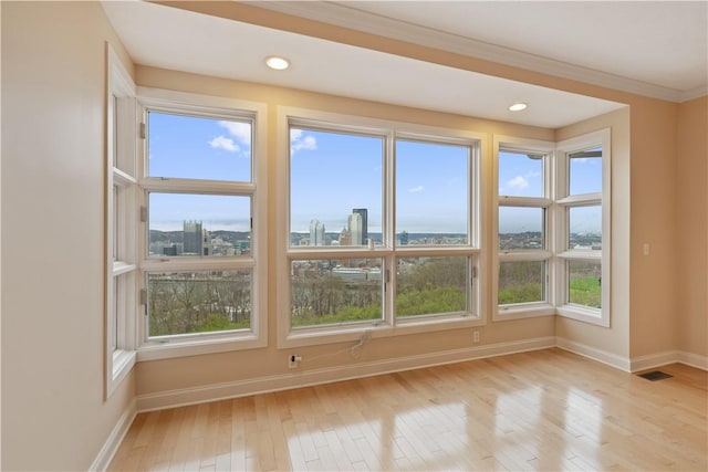 interior space with recessed lighting, light wood-type flooring, crown molding, and baseboards