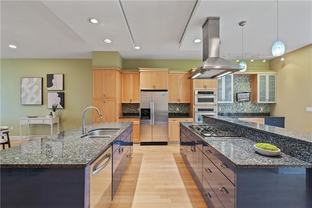 kitchen featuring a sink, light brown cabinetry, island exhaust hood, a large island, and appliances with stainless steel finishes