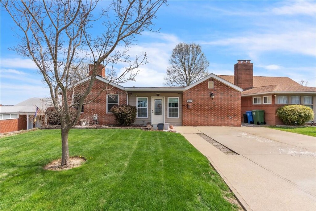 4207 Greenridge Rd, Castle Shannon, PA 15234 - ranch-style home featuring brick siding, a front lawn, a chimney, and concrete driveway