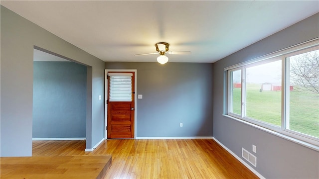 393 Eagle Mill Rd, Connoquenessing Twp, PA 16001 - unfurnished room featuring light wood-style floors, a ceiling fan, and baseboards