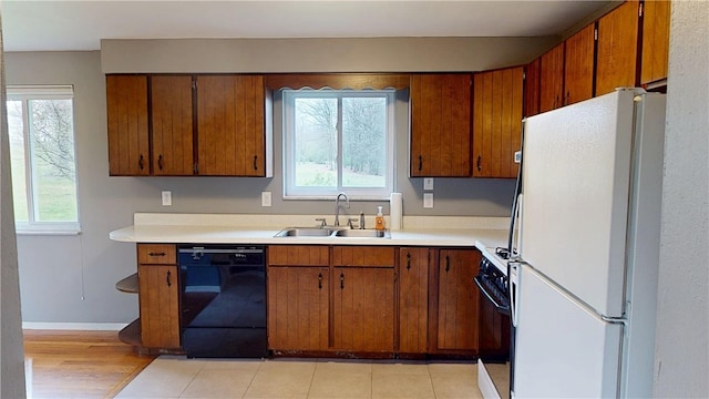 393 Eagle Mill Rd, Connoquenessing Twp, PA 16001 - kitchen with freestanding refrigerator, dishwasher, a sink, range with gas stovetop, and light countertops