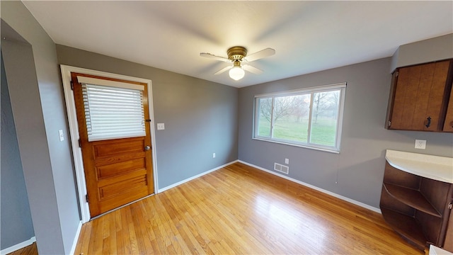 393 Eagle Mill Rd, Connoquenessing Twp, PA 16001 - unfurnished dining area with light wood-style flooring, ceiling fan, and baseboards