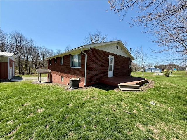 393 Eagle Mill Rd, Connoquenessing Twp, PA 16001 - view of home's exterior with brick siding, central AC, a yard, and a wooden deck