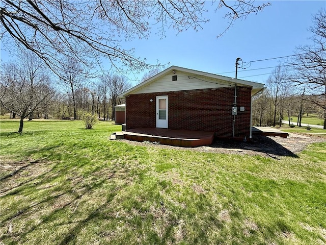 393 Eagle Mill Rd, Connoquenessing Twp, PA 16001 - view of side of home featuring a deck, brick siding, and a lawn