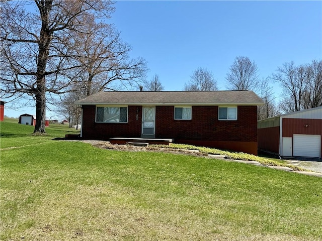 393 Eagle Mill Rd, Connoquenessing Twp, PA 16001 - ranch-style home with brick siding, a front yard, an outbuilding, and a detached garage