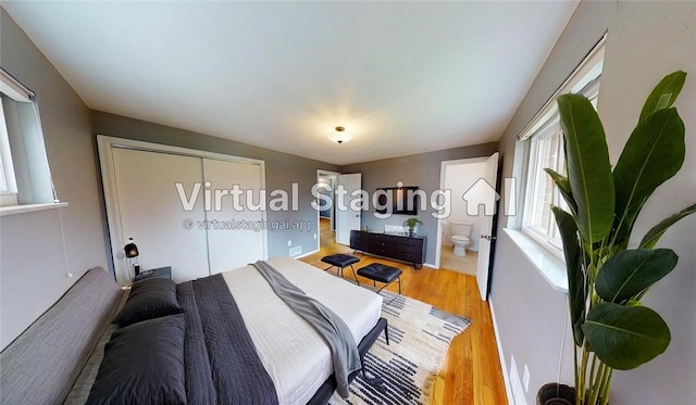 393 Eagle Mill Rd, Connoquenessing Twp, PA 16001 - bedroom featuring multiple windows, light wood-style flooring, a closet, and ensuite bathroom