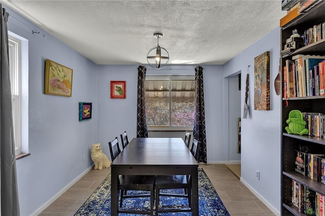 3125 Villawood Ave, Brentwood, PA 15227 - dining space with a textured ceiling, baseboards, and wood finished floors