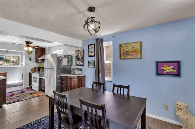 3125 Villawood Ave, Brentwood, PA 15227 - dining room featuring a textured ceiling, baseboards, and wood finished floors