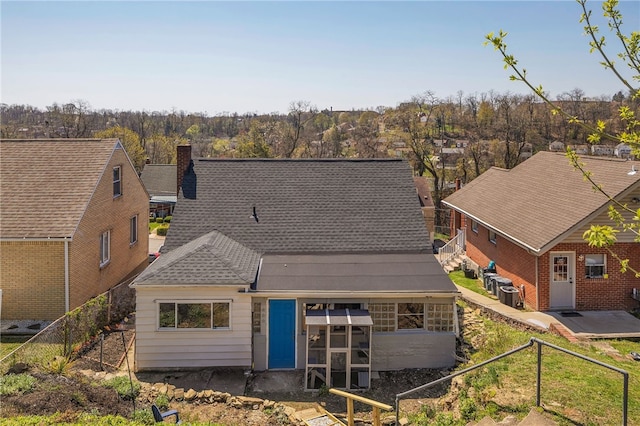 3125 Villawood Ave, Brentwood, PA 15227 - rear view of house with fence, central AC unit, and a chimney