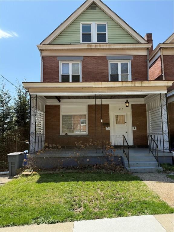 545 Forest Ave, Bellevue, PA 15202 - traditional style home featuring brick siding, a porch, and a front yard
