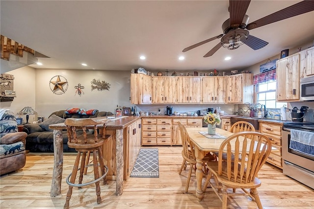 2072 Washington, Washington Twp Wml, PA 15613 - kitchen featuring light wood-type flooring, stainless steel appliances, light brown cabinetry, and open floor plan