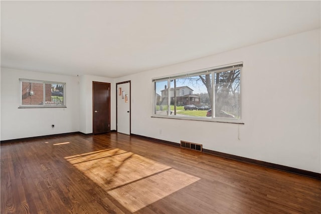 23 Pontiac Rd, Bethel Park, PA 15241 - unfurnished living room featuring wood finished floors, visible vents, baseboards, and a healthy amount of sunlight