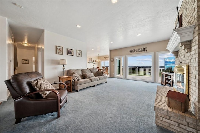 living room featuring a fireplace, carpet, and recessed lighting