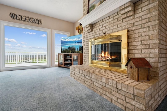 unfurnished living room with carpet floors, a brick fireplace, and visible vents