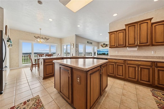 kitchen featuring brown cabinetry, a wealth of natural light, and a kitchen island