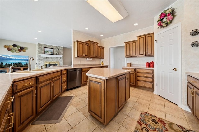 kitchen featuring light countertops, dishwasher, light tile patterned floors, and a sink