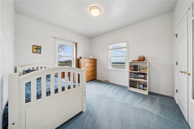 carpeted bedroom with baseboards, multiple windows, and visible vents