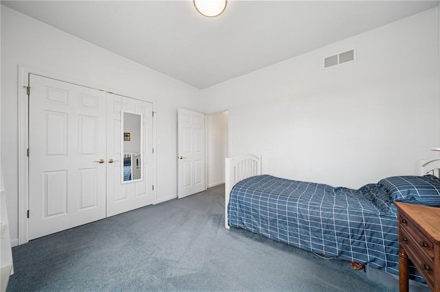 carpeted bedroom featuring visible vents