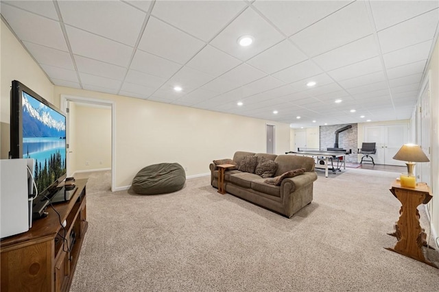 carpeted living room with baseboards, recessed lighting, and a drop ceiling