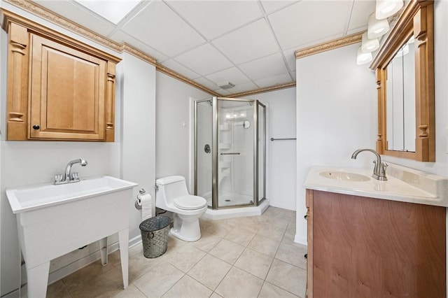 bathroom featuring tile patterned flooring, toilet, a sink, baseboards, and a stall shower