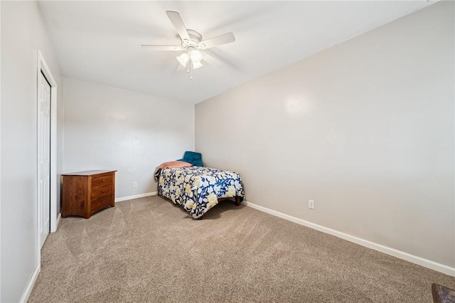 carpeted bedroom with baseboards, a ceiling fan, and a closet