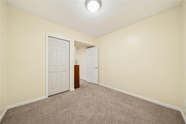 unfurnished bedroom with baseboards and carpet