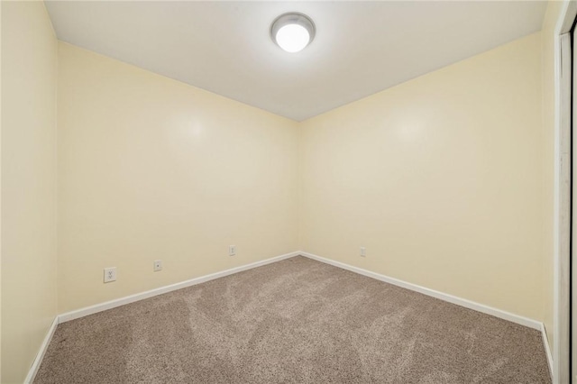 carpeted spare room with baseboards