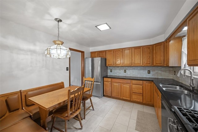 2314 Mcmonagle Ave, Banksville/Westwood, PA 15216 - kitchen featuring brown cabinets, tasteful backsplash, a sink, and freestanding refrigerator