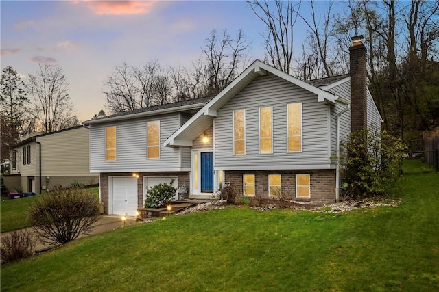 2240 Chapparal Dr, Plum Boro, PA 15239 - split foyer home with concrete driveway, a front lawn, a chimney, and a garage