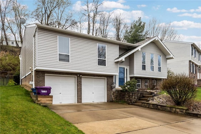 2240 Chapparal Dr, Plum Boro, PA 15239 - split foyer home featuring concrete driveway, brick siding, a front yard, and a garage