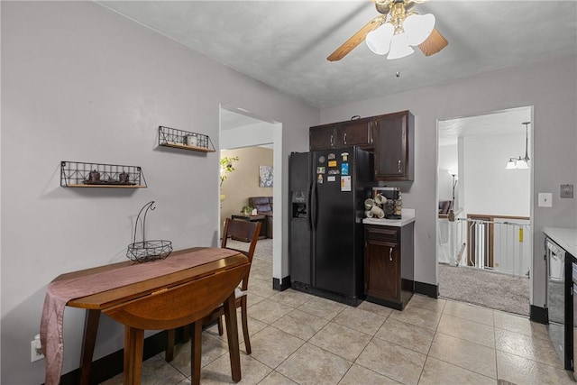 2240 Chapparal Dr, Plum Boro, PA 15239 - kitchen with light countertops, a ceiling fan, light tile patterned floors, black refrigerator with ice dispenser, and dark brown cabinetry