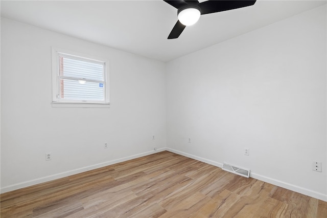 empty room with baseboards, visible vents, ceiling fan, and light wood-style floors